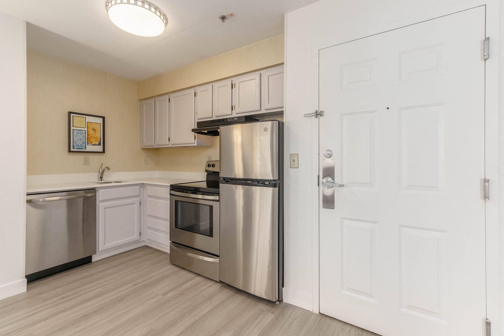 a kitchen with stainless steel appliances and white cabinets